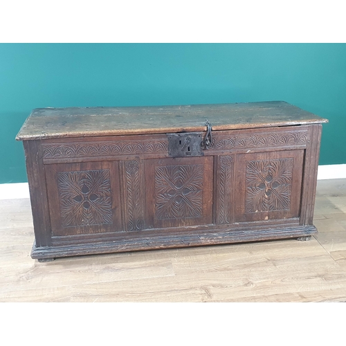 621 - A 17th C joined Oak Coffer with moulded two plank lid and clasp lock above quatrefoil leafage carved... 