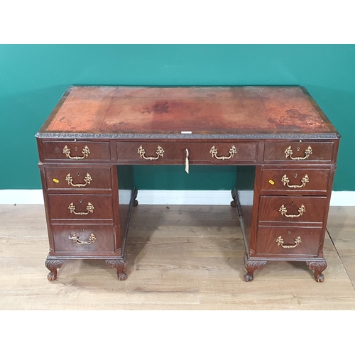 1 - A Georgian Style mahogany Kneehole Desk, the top with inset writing surface, with nine fitted drawer... 