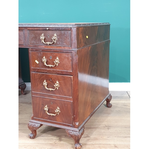 1 - A Georgian Style mahogany Kneehole Desk, the top with inset writing surface, with nine fitted drawer... 