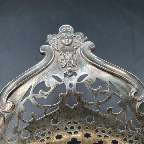 102 - An Edward VII silver pierced oval Bowl with cherub and scroll border on four scroll feet, Birmingham... 