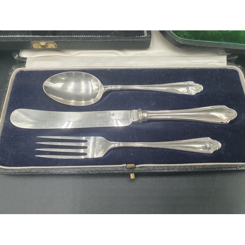 107 - A George V silver Christening Knife, Fork and Spoon, Birmingham 1926, in case, and two other boxed S... 