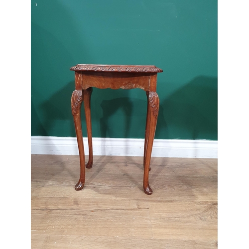 11 - A nest of three walnut veneered Occasional Tables on cabriole supports and a wing back Armchair with... 