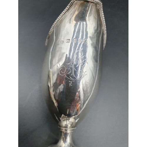 134 - A George III silver helmet shape Cream Jug with beaded rim, engraved initials on square base, London... 