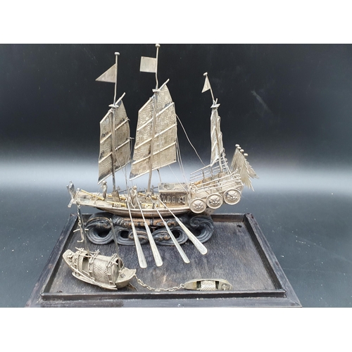 143 - A Chinese silver three masted Sailing Boat with figures and oars, and two smaller vessels, all under... 