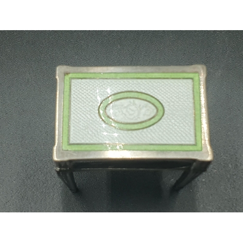 145 - A silver and green and white enamel Matchbox Holder in the form of a table, A/F