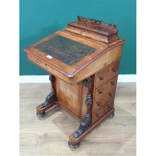 15 - A Walnut Davenport with hinged lid with inset writing surface, with four fitted side drawers, with c... 