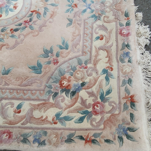 16 - A cream and pink ground Rug with floral multi borders with large central circular floral motif, 78