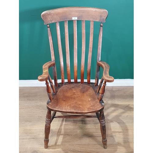 33 - An ash and elm Lathe back Elbow Chair on turned supports and H Stretcher. (R4).