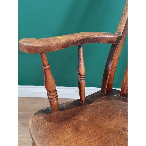 33 - An ash and elm Lathe back Elbow Chair on turned supports and H Stretcher. (R4).