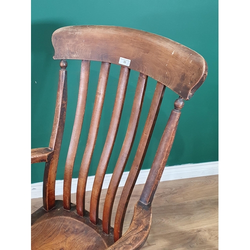 33 - An ash and elm Lathe back Elbow Chair on turned supports and H Stretcher. (R4).