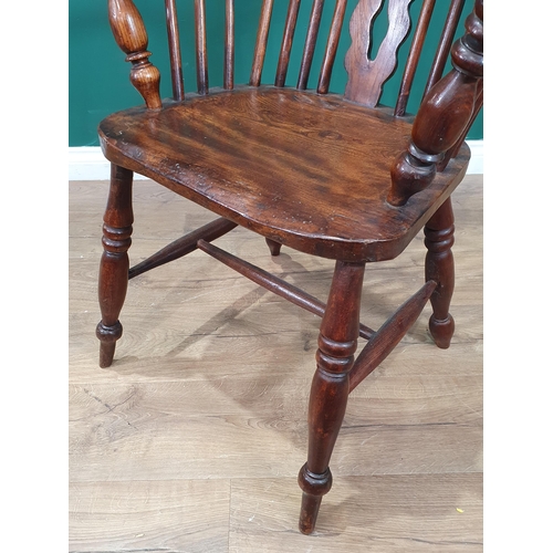 35 - An ash and elm Windsor Elbow Chair with pierced shaped splat, raised on turned supports and H stretc... 