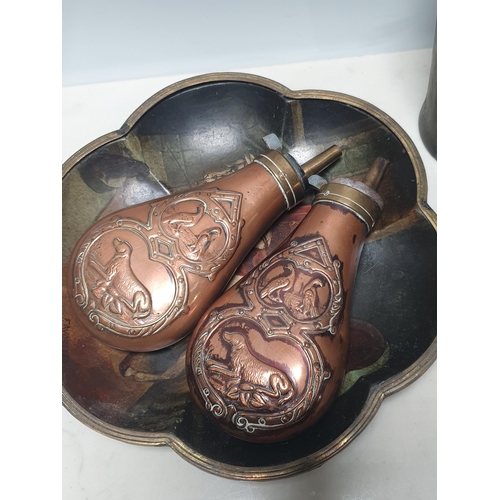 396 - Two copper embossed Shot Flasks with gun dog decorations, two Horn Beakers, a papier mache Tray with... 