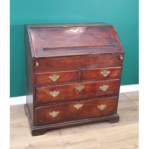 43 - An 18th Century elm Bureau, the interior fitted pigeon holes and drawers (one drawer missing) either... 