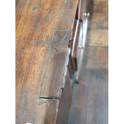 43 - An 18th Century elm Bureau, the interior fitted pigeon holes and drawers (one drawer missing) either... 