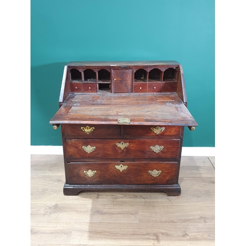 43 - An 18th Century elm Bureau, the interior fitted pigeon holes and drawers (one drawer missing) either... 