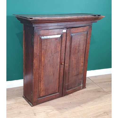 44 - An 18th Century fruitwood Cupboard with pair of fielded panelled doors enclosing an arrangement of a... 