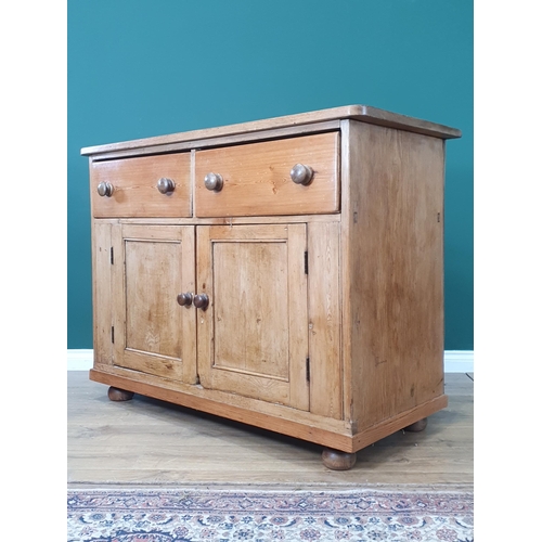 482 - A large Pine two door cupboard fitted two drawers, raised on bun feet 3ft 3