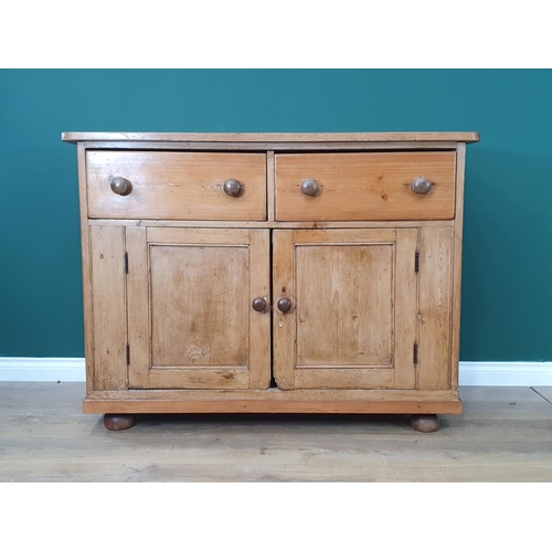 482 - A large Pine two door cupboard fitted two drawers, raised on bun feet 3ft 3