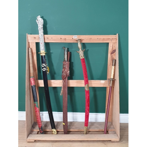 487 - A collection of various swords in scabbards (stand not included) (R2)