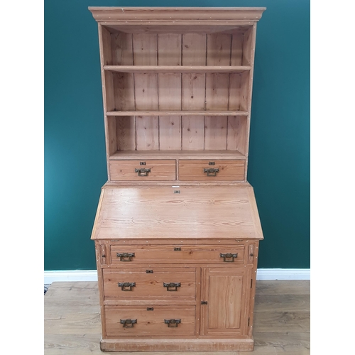 490 - A pitch pine Secretaire Bookcase, the top with open shelves and a pair of fitted drawers above the f... 