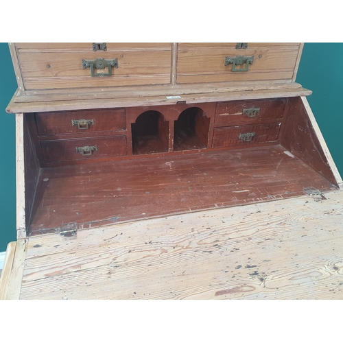 490 - A pitch pine Secretaire Bookcase, the top with open shelves and a pair of fitted drawers above the f... 