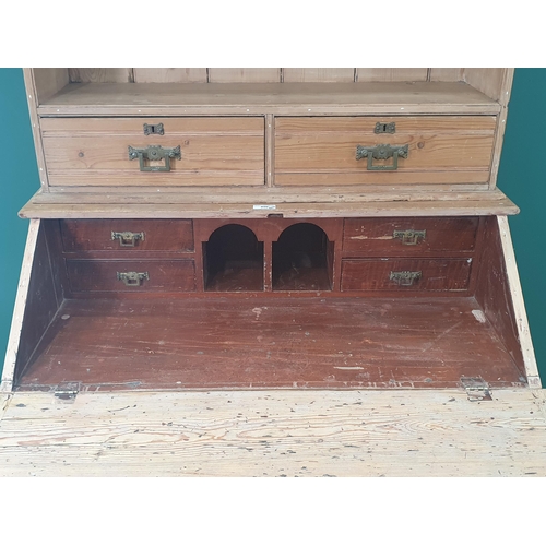 490 - A pitch pine Secretaire Bookcase, the top with open shelves and a pair of fitted drawers above the f... 