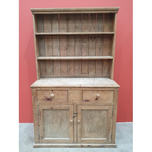 496 - A rustic pine Dresser and Rack, the base fitted pair of drawers above pair of cupboard doors raised ... 