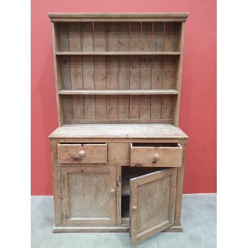 496 - A rustic pine Dresser and Rack, the base fitted pair of drawers above pair of cupboard doors raised ... 