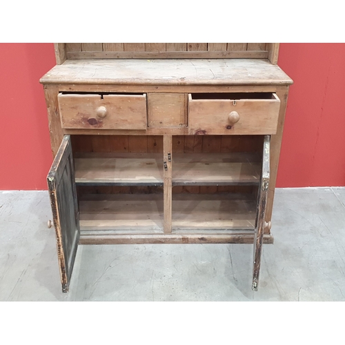 496 - A rustic pine Dresser and Rack, the base fitted pair of drawers above pair of cupboard doors raised ... 