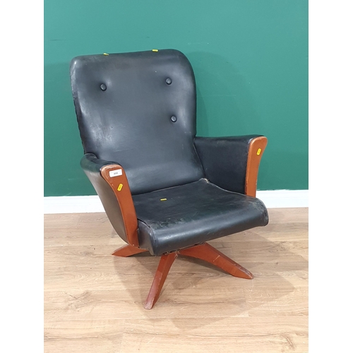 499 - A mid-century revolving Armchair with faux black leather upholstery (R6)