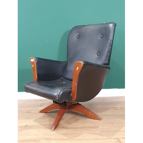 499 - A mid-century revolving Armchair with faux black leather upholstery (R6)