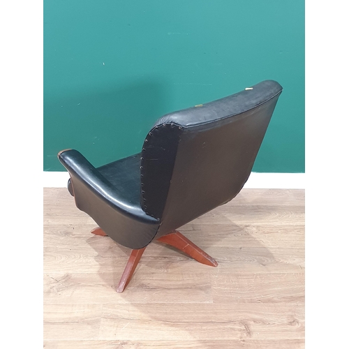 499 - A mid-century revolving Armchair with faux black leather upholstery (R6)