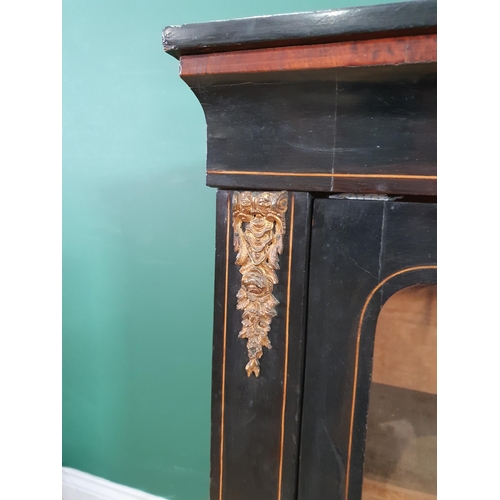 506 - A 19th Century ebonised and walnut veneered Music Cabinet fitted glazed door with gilded brass mount... 