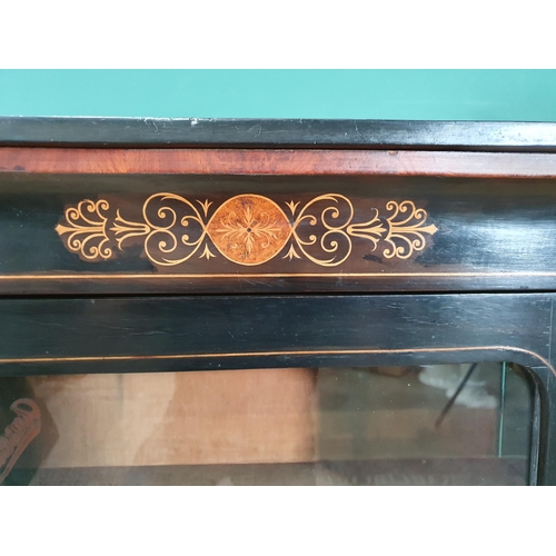 506 - A 19th Century ebonised and walnut veneered Music Cabinet fitted glazed door with gilded brass mount... 