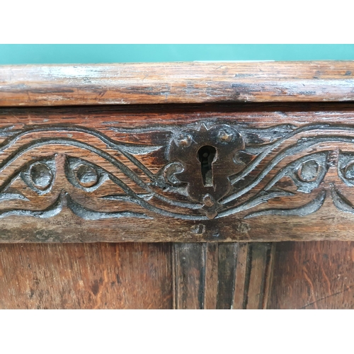 514 - A 17th Century joined oak Coffer with sunken four panel lid above plain four panel front with applie... 