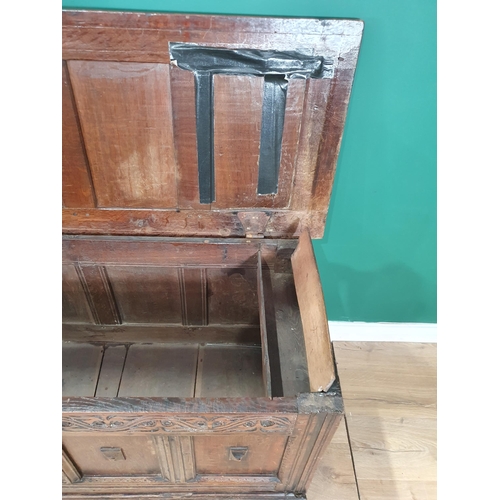 514 - A 17th Century joined oak Coffer with sunken four panel lid above plain four panel front with applie... 