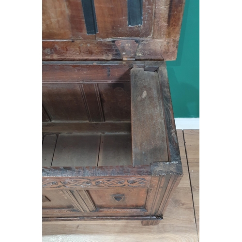 514 - A 17th Century joined oak Coffer with sunken four panel lid above plain four panel front with applie... 