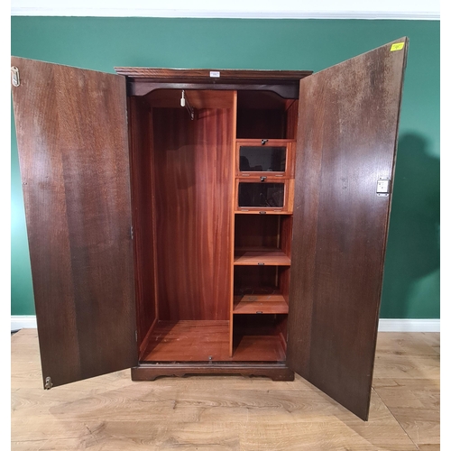 519 - An oak two door Wardrobe with arcaded design, strap hinges and fitted interior 5ft 6in H x 3ft 2in W... 