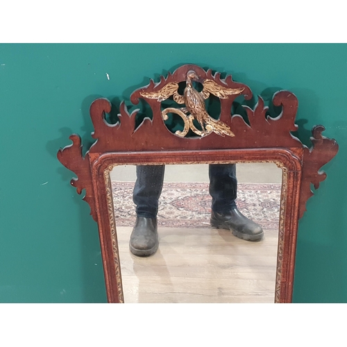 52 - A Georgian mahogany and walnut Wall Mirror with gilt slip and Hoho bird surmount and shaped surround... 