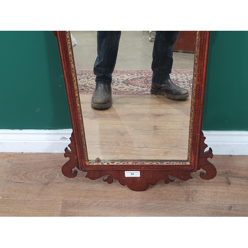 52 - A Georgian mahogany and walnut Wall Mirror with gilt slip and Hoho bird surmount and shaped surround... 