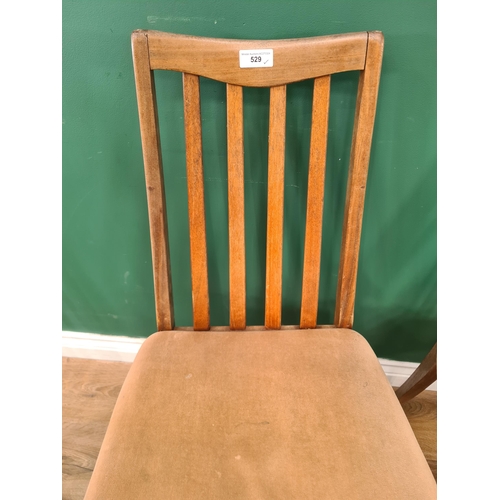 529 - A set of four teak G-Plan Dining Chairs with beige upholstered seats on square tapered supports, A/F... 