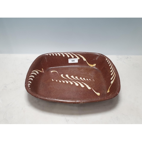 545 - A 19th Century English Slipware Baking Dish, with brown glaze and feathered white slip trail decorat... 