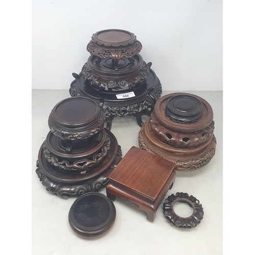 550 - A collection of twelve assorted hardwood Chinese Pot Stands some with pierced decorations and shaped... 