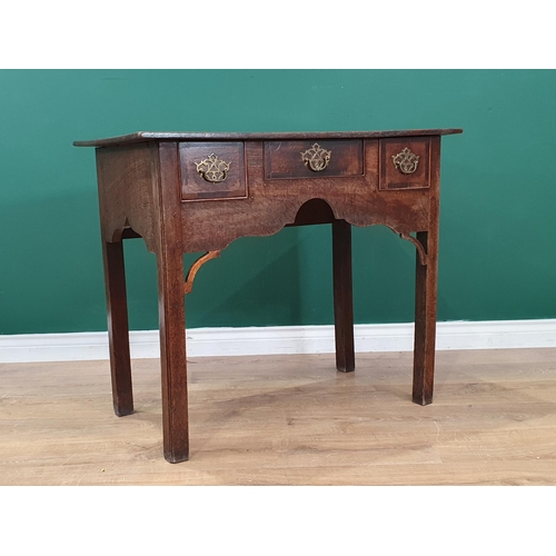 60 - An 18th Century oak Lowboy fitted three drawers around a shaped apron with pierced corner brackets o... 