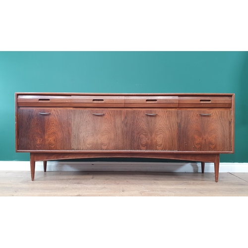 620 - A mid-Century teak Sideboard fitted four frieze drawers above four cupboard doors 6ft 1in W x 2ft 6i... 