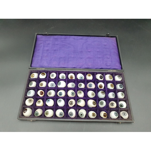 65 - A Case containing fifty glass Artificial Eyes, together with trade label for Hermann Hellbach, Lausc... 