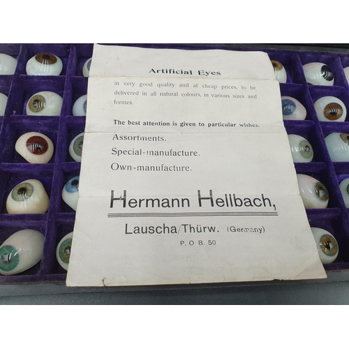 65 - A Case containing fifty glass Artificial Eyes, together with trade label for Hermann Hellbach, Lausc... 