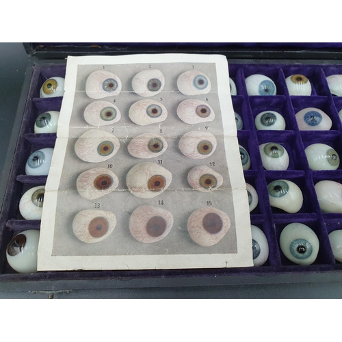 65 - A Case containing fifty glass Artificial Eyes, together with trade label for Hermann Hellbach, Lausc... 