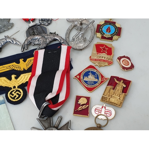 67 - A collection of Polish, German and Japanese Military Badges and other effects including Police Airfo... 