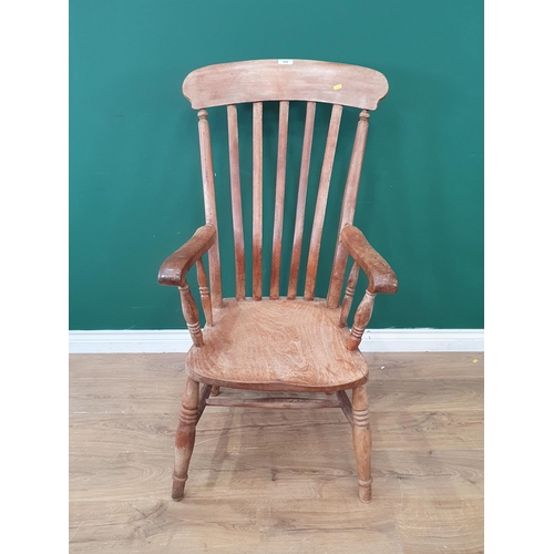 688 - A Windsor style lathe back Elbow Chair on turned supports and H stretcher. (R9).